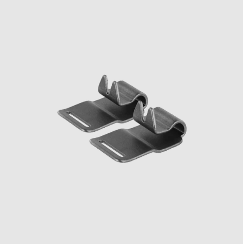 Two metallic clip-like objects on a light gray background